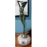 An Art Deco Green Patinated Bronze Figure of a Nude; standing with her arms on her head, on circular