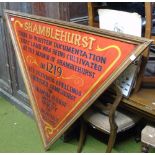 A Triangular Hand Painted Sign on Red Ground.