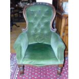 A Mahogany Deep Buttoned Balloon Back Arm Chair, upholstered in green.