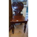 A Victorian Mahogany Hall Chair; with carved back panel.