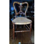 A Late 19th Early 20th Century Bedroom Chair; with delicate turned legs and a caned seat.