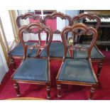 A Set of Six Victorian Carved Mahogany Dining Chairs; on fluted front supports with an upholstered