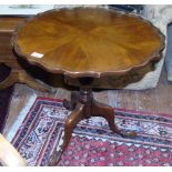 A Georgian Style Mahogany Circular Top Wine Table; with pie crust edge on a turned pillar and carved