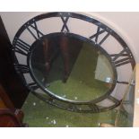 A Circular Steel Framed Mirror; with frame as a chapter ring with Roman numerals.