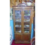 A 20th Century Oak Bookcase, having leaded glass panels fitted to the doors.