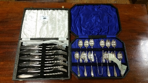 A Cased Set of Plated Teaspoons & Tongs, & a Cased Set of Fish Eaters (2).