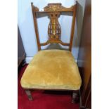 A Pair of Edwardian Rosewood and String Inlaid Nursing Chairs; with pierced carved inlaid splats and