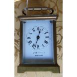 A French Brass Cased Carriage Clock; the white enamel dial with Roman numerals.