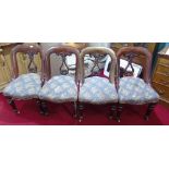 A Set of Four Mahogany Spoon Back Dining Chairs with upholstered seats.