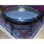 A Victorian Ebonised Shaped Oval Top Centre Table with Gilt Highlights; the top with inset mirror