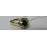 .A 9ct Diamond and Sapphire Cluster Ring