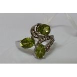 A Silver Diamond and Peridot Cluster Ring.