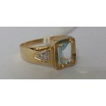 A 10ct Gold Diamond and Aquamarine Ring.