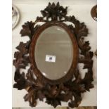 A Bavarian Black Forest Leaf Decorated Mirror, 17 x 11.5ins.