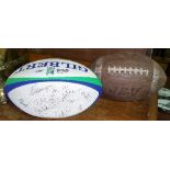 A Signed Gilbert Rugby Ball, along with a Signed Spalding American Football.