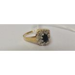 A Gold Diamond and Sapphire Cluster Ring.