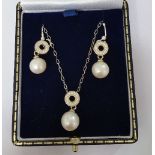 A Pair of Silver Pearl Set Earring along with a Matching Pendant.