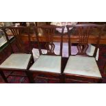 A Set of Three 19th Century Mahogany Dining Chairs each with vase splat, drop in seats over square