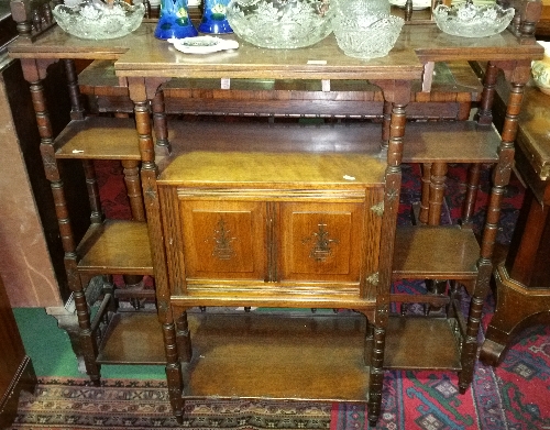 A Late 19th Century Walnut Four-Tier Open Bookcase with spindle gallery top, twin panel doors, c.