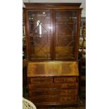 A String Inlaid Mahogany Finish Bureau Bookcase; the upper section fitted three shelves enclosed