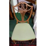 An Edwardian Solid Satinwood Side Chair; with a highly carved shield shape back and stuff-over