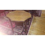 A Late 19th/Early 20th Walnut Scalloped Edge Centre Table; with raised under tier and reeded legs on