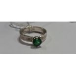 A Ladies Green Stone Ring in a Silver Coloured Band, (Vendor Paid €100).