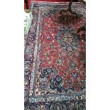 A Persian Tabriz Carpet with a Traditional Medallion Design.