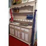 A Painted Pine Dresser; with shelved back over a drawer and cupboard base, 182 cm high.