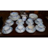 A Victorian 'Osborne' Tea Set, wrythen shaped with pale blue trailing vines, along with a top