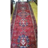 A Large Red Ground Iranian Hand Woven Runner.