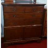 A 19th Century Cupboard; with two short and two long drawers above a pair of doors, on bracket