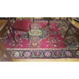 A Red and Brown Multicoloured Persian Carpet with a Traditional Medallion Design.