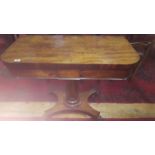 A Regency Mahogany Foldover Card Table; raised on an octagonal vase shaped pillar and platform