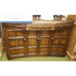 A Jacobean Revival Sideboard of Bow Form; with drawers and cupboards, along with a stool.