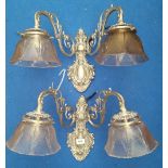 A LOVELY PAIR OF BRASS BACKED TWIN BRANCH WALL LIGHTS silvered, with glass shades.