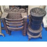 A 19TH CENTURY CAST IRON GRATE AND A STOVE.
