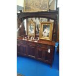 AN ARTS AND CRAFTS MAHOGANY SIDEBOARD with mirror back.