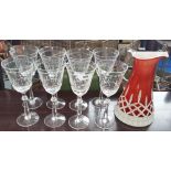 A LOVELY SUITE OF EIGHT RED WINE GLASSES & A BOHEMIAN CRANBERRY & WHITE GLASS JUG.