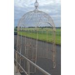 A LARGE CREAM PAINTED GAZEBO.