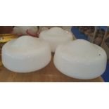 A GROUP OF THREE WHITE GLASS DOME SHADES.