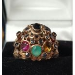 A 14ct GOLD LADY'S DRESS RING set high with semi-precious stones. Very decorative.