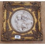 A 20TH CENTURY PLASTER WALL PLAQUE of two children in a gilt frame.
