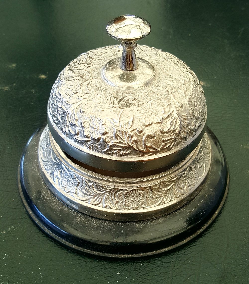 A SILVER-PLATED HOTEL BELL.