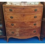 A GEORGIAN MAHOGANY BOW FRONT CHEST with four graduated drawers.