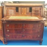 A 19TH CENTURY MAHOGANY CONTINENTAL CYLINDER DESK with unusual mechanism, on square supports.