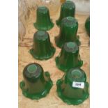 A GROUP OF SEVEN GREEN GLASS SHADES.