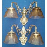 A LOVELY PAIR OF BRASS BACKED TWIN BRANCH WALL LIGHTS silvered, with glass shades.