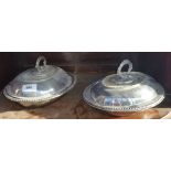 A PAIR OF OVAL SILVER-PLATED ENTRÉ DISHES, having beaded borders, the lids with removable handles.