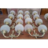 A SET OF EIGHT TWIN BRANCH BRASS WALL LIGHTS with glass dome shades.